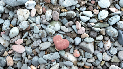 heart-shaped stone on a background of sea stones