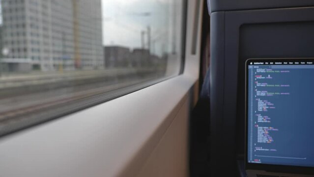 Selective focus, and defocus of open laptop or notebook, working as programmer and do some coding on the train during commute. 