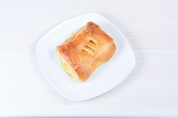 puff pastry multi-cheese cake on wooden background