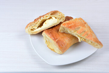 puff pastry multi-cheese cake on wooden background