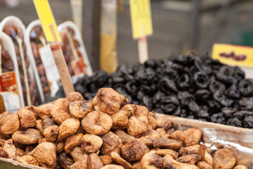 Selective blur on dried figs for sale on a market in Belgrade, Serbia piled on stall in pijaca. These are the most traditional fruits of Balkans in Summer, also called prunus avium or wild cherry