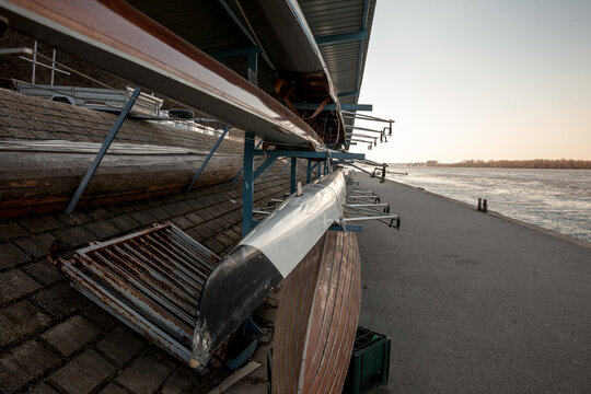 Selective blur on Rowing boats, Sweep oar and coxed four style, being stored and maintained at sunset by the danube river. A Sweep oar boat & a coxed four are used by 4 or eight persons propelling it