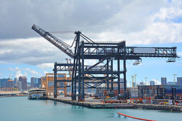 Fototapeta na wymiar Cargo ship cranes at the the port of Honoluu