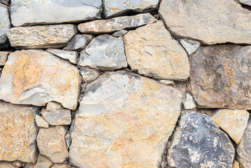 photo background of an old stone wall made of stones