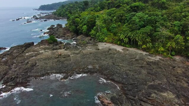 Drone Aerial View Of Tropical Rocky Shorefront on South American Rainforest Coastline.
