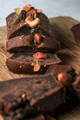 Homemade vegan banana bread with nut sliced on a cutting Board on a Wooden Kitchen Table. Healthy Breakfast Recipe