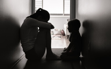 Sad mother and child at home in a dark room  - obrazy, fototapety, plakaty
