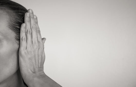 Hand covering ear blocking out the noise 