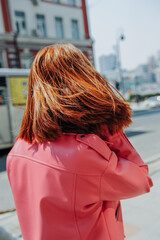 stylish image of urban fashion. bright pink leather jacket on woman without face. spring female look. cozy style clothes. selective focus