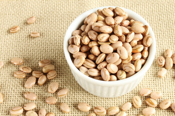 Ramekin grains. Carioca beans in a ramekin on the jute fabric.