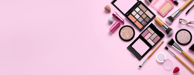 Makeup brushes and decorative cosmetics on pink background with space for text, top view