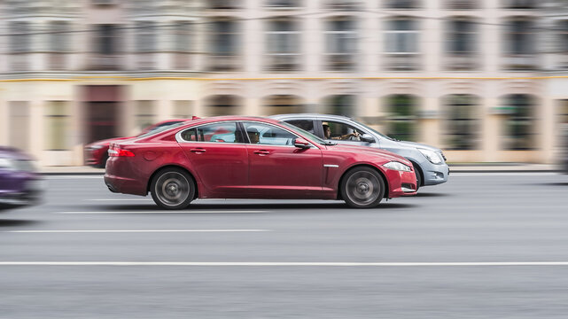 Jaguar XF X250 car moving fast on the street of Moscow. Vehicle driving along the street in city with blurred background.