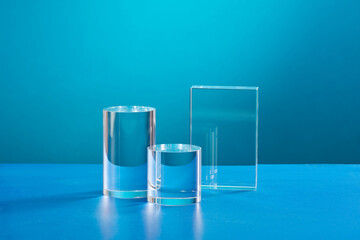 Front view of transparent podium decorated in blue background 