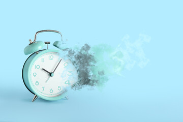 Fototapeta na wymiar Crumbling alarm clock on blue background