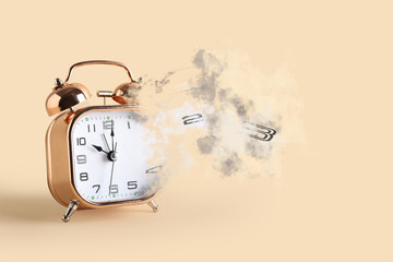 Crumbling alarm clock on beige background