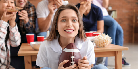 Young woman with friends watching rugby on TV