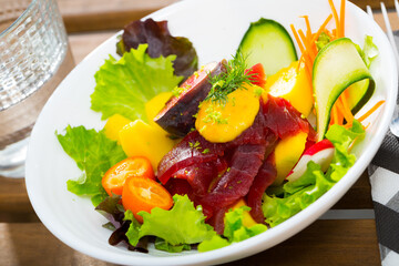 Healthy salad with fresh tuna, vegetables and fruits