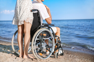Young woman and her boyfriend with physical disability at sea resort