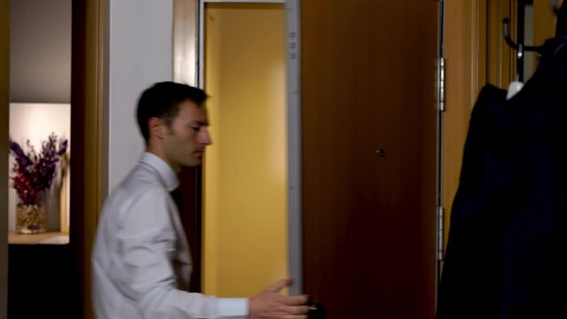 Young Businessman In Suit And Necktie Grabbing Briefcase Bag And Leave His Modern Apartment Flat Ready For Start Another Day In The Office