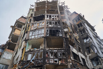 Fototapeta premium War of Russia against Ukraine. A residential building damaged by an enemy aircraft in the Ukrainian. Consequences of the war, damaged grocery market by the troops of the Russian army.