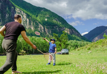 Fototapeta na wymiar people playing in badminton in the mountains