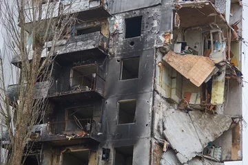 Foto op Aluminium War of Russia against Ukraine. A residential building damaged by an enemy aircraft in the Ukrainian. Consequences of the war, damaged grocery market by the troops of the Russian army. © Alexey Lesik