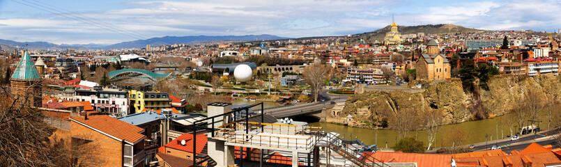 Panorama of historic center of Tbilisi city on banks of Mtkvari River on sunny spring day, Georgia © JackF