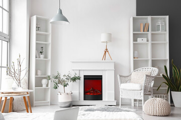 Interior of light room with fireplace and shelf units near white wall