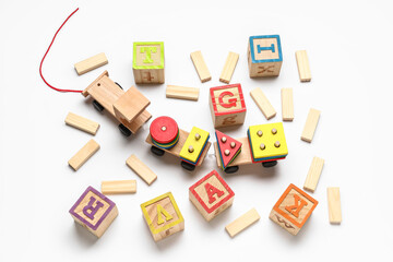 Wooden cubes with letters and blocks on white background