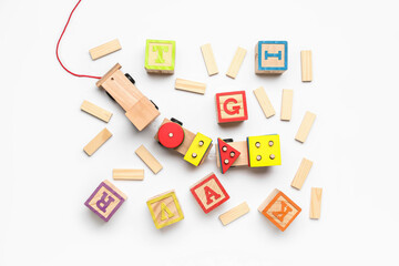 Wooden cubes with letters and blocks on white background