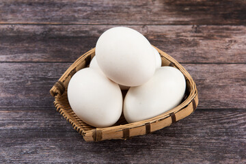 Fresh goose eggs on wooden table