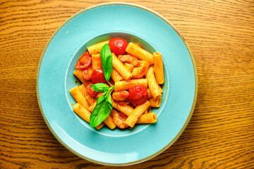 Italian recipe Pasta tortilloni with green pea, mint leaves, cheece, smoked bacon and cheese. Top view, blue background