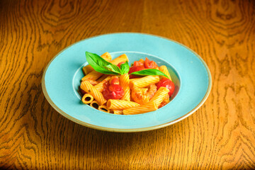 Italian recipe Pasta tortilloni with green pea, mint leaves, cheece, smoked bacon and cheese. Top view, blue background