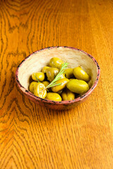 Green olives on the ceramic dish