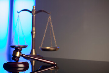 Lawyer office. Law symbols composition: judge’s gavel and scale. Blue light background.