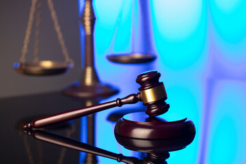 Lawyer office. Law symbols composition: judge’s gavel and scale. Blue light background.