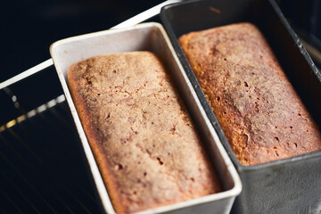 The process of making rye bread. The finished bread is taken out of the oven. Front view.