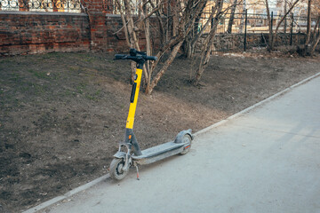 Dirty electric scooter on the street.