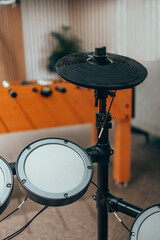 Electric drum kit. A drum cymbal. A drum barrel.