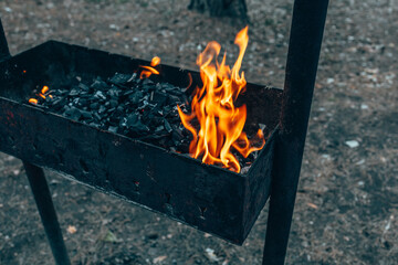Fire in the grill. Outdoor recreation. Cooking outside on an open fire. Burning coals.