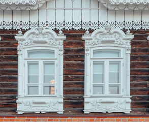 Old carved windows of a wooden house. Old Russian architecture. Carved platbands. An architectural monument.