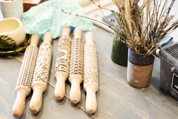 Professional working tools for working with clay.  Pottery shovels, brushes, rolling pin on wooden table.