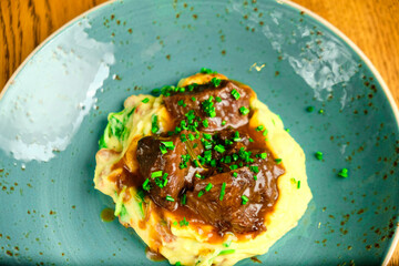 Beef risotto served in a plate with sauce a
