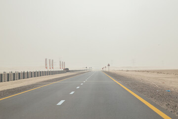 Dessert road in sandstorm hazy out of focus with grain