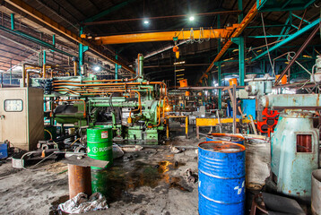The atmosphere and situation of an aluminum processing factory with various machines used as...