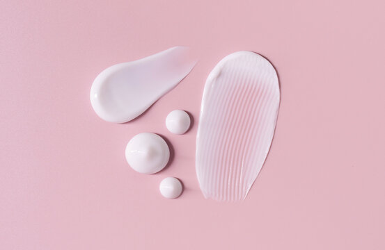 Cosmetic Smears Cream Texture On Pastel Pink Background	
