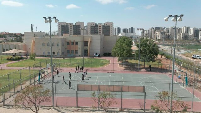 basketball  playground at the high school , shot from above with drone, at southern district city in israel named by netivot