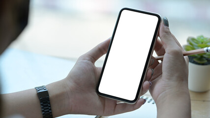 Close up view  young woman hands holding smart phone with blank screen for advertise text.