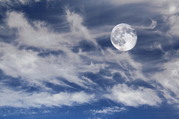 Naklejka na ściany i meble Waning moon on blue sky with cirrus clouds