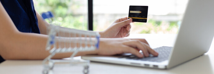 women use laptop to register online purchases using credit card payments, Convenience in the world of technology and the internet, Shopping online and banking online concept...